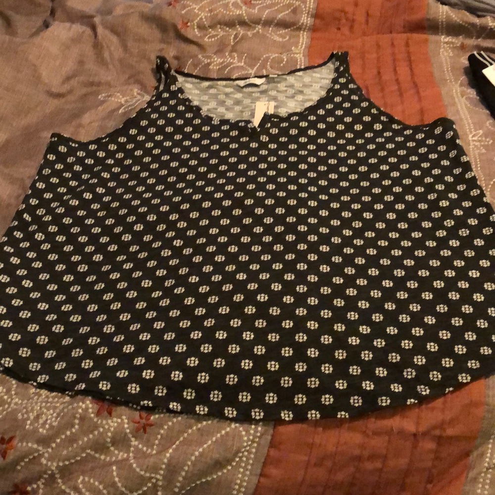 Black sleeveless shirt with small white flowers.